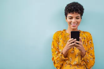 black lady looks at mobile